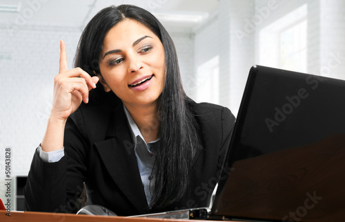 Photo: Businesswoman having an idea while working Businesswoman having an idea while working