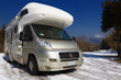 Camper parked on snow in the mountain