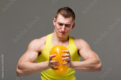 Photo: Muscular young man flexing arm muscles Muscular young man flexing arm muscles