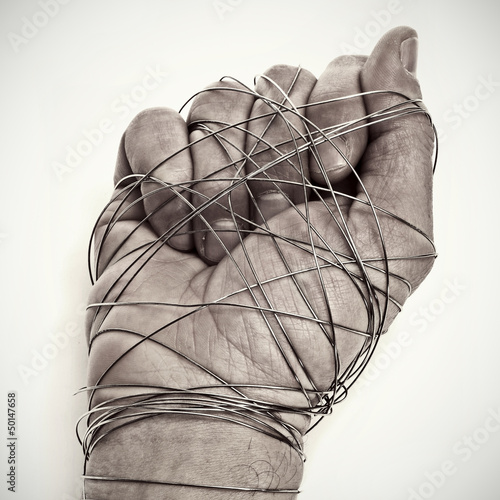 Photo: man hand tied with wire man hand tied with wire