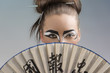 pretty brunette in japan style with fan on the face