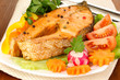 Appetizing grilled salmon with vegetables close up