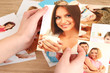 Photos in hands on wooden table