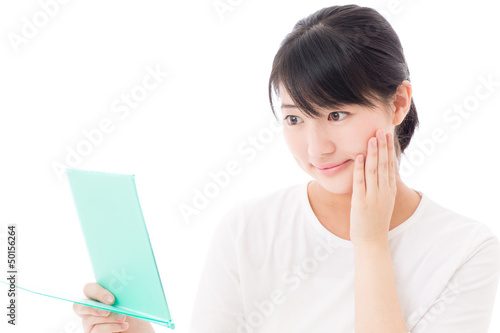 Photo: a young asian woman making up a young asian woman making up