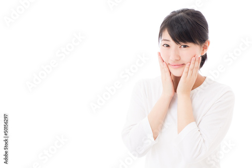 Photo: a young asian woman making up a young asian woman making up