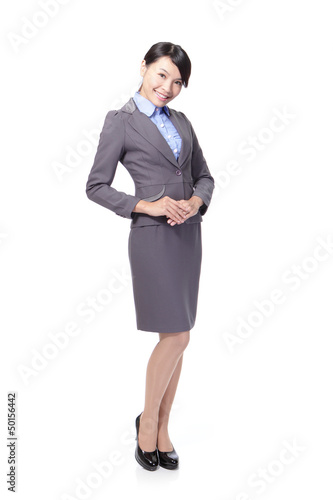 Photo: business woman standing and smiling business woman standing and smiling