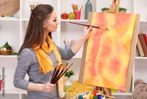 Photo: beautiful young woman painter at work, beautiful young woman painter at work,