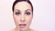 Woman puts red lipstick