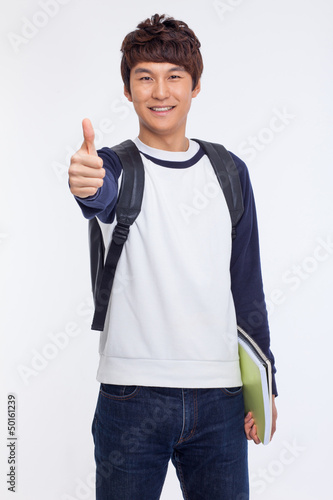Photo: Young Asian student showing thumb Young Asian student showing thumb