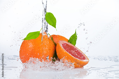 Photo: water splash in kiwi fruit isolated on white bacground water splash in kiwi fruit isolated on white bacground