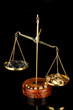 Gold and coal on scales on dark grey background