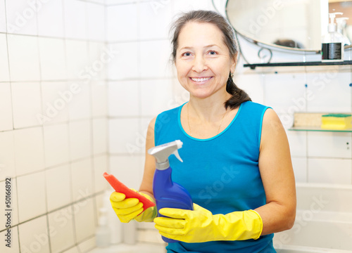 Photo: mature woman cleans bathroom mature woman cleans bathroom