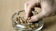 Man putting out cigarette in ashtray