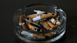 Cigarette falling into ashtray