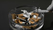 Hand tipping ash from cigarette into ashtray