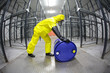 Photo: fully protected technician,rolling a barrel wh toxic substance fully protected technician,rolling a barrel wh toxic substance