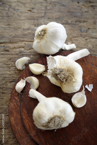 Photo: Bulbs of garlic on cutting board Bulbs of garlic on cutting board