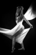 Beautiful woman with white tissue on black background