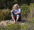 serene senior woman laughing and enjoying the sun