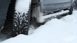 Snowtire on SUV during snowstorm.