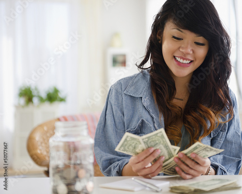 Photo: Pacific Islander woman counting money Pacific Islander woman counting money