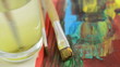 brush with yellow water color is cleaned in water glass.