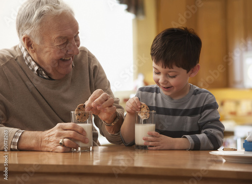 Photo: Caucasian grandfather and grandson eating milk and cookies Caucasian grandfather and grandson eating milk and cookies