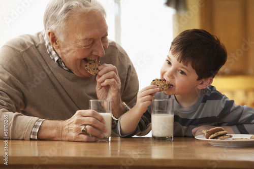 Photo: Caucasian grandfather and grandson eating milk and cookies Caucasian grandfather and grandson eating milk and cookies