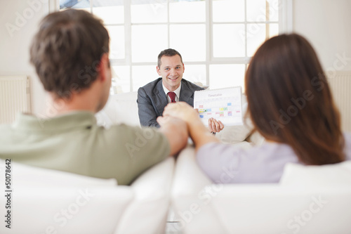 Photo: Hispanic couple talking with financial advisor Hispanic couple talking with financial advisor