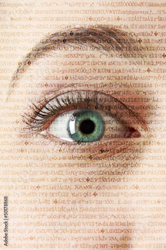 Photo: Close up of woman's eye with text in background Close up of woman's eye with text in background