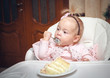 Little girl with a sweet cake in birthday