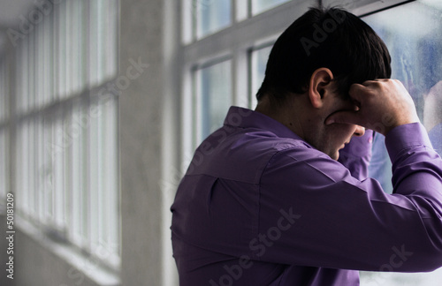 Photo: A man holds his head, hi have big problems, stress A man holds his head, hi have big problems, stress