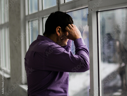 Photo: A man holds his head, hi have big problems, stress A man holds his head, hi have big problems, stress
