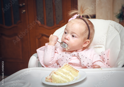 Photo: Little girl with a sweet cake in birthday Little girl with a sweet cake in birthday