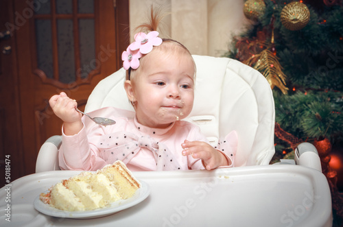 Photo: Little girl with a sweet cake in birthday Little girl with a sweet cake in birthday