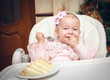 Little girl with a sweet cake in birthday