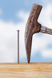 Hammer and nail with wooden board
