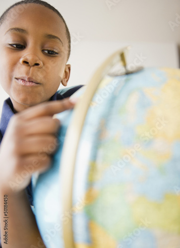 Photo: Black boy looking at globe Black boy looking at globe