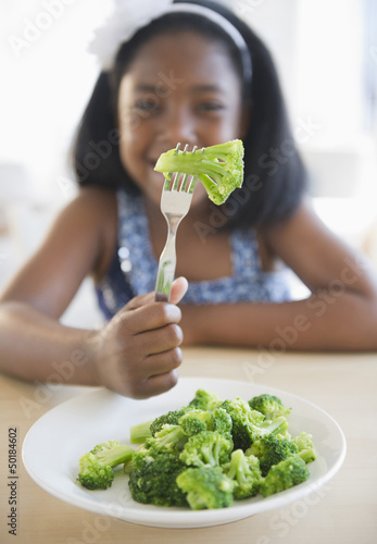 Photo: Black girl eating broccoli Black girl eating broccoli