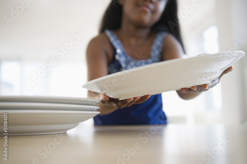 Photo: Black girl setting the table Black girl setting the table