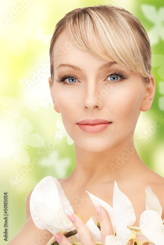 Photo: beautiful woman with orchid flower and butterflies beautiful woman with orchid flower and butterflies
