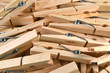 Pile of wooden clothespins as background.
