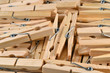 Pile of wooden clothespins as background.