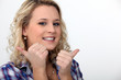 blond woman doing thumbs-up gesture
