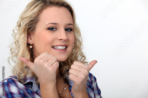Photo: blond woman doing thumbs-up gesture blond woman doing thumbs-up gesture