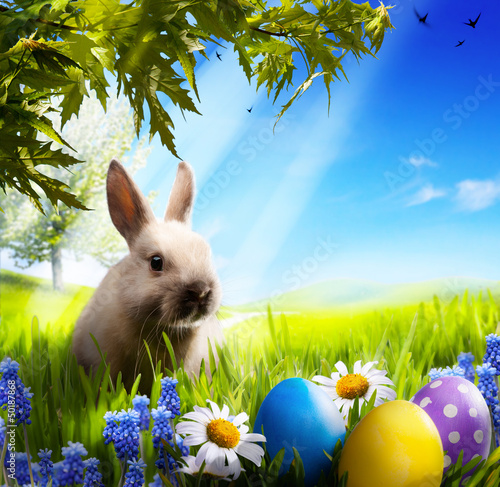Photo: art Little Easter bunny and Easter eggs on green grass art Little Easter bunny and Easter eggs on green grass