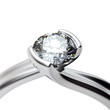 Wedding ring with diamond on white background. Sign of love
