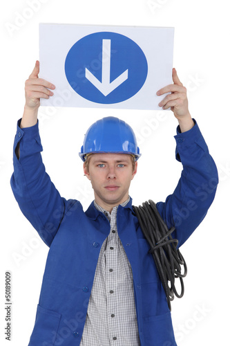 Photo: Electrician holding a one way sign Electrician holding a one way sign