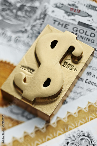 Photo: Gold ingot with dollar sign symbol Gold ingot with dollar sign symbol