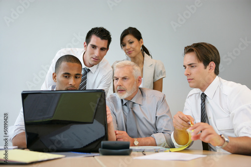 Photo: Business team sitting at a computer Business team sitting at a computer